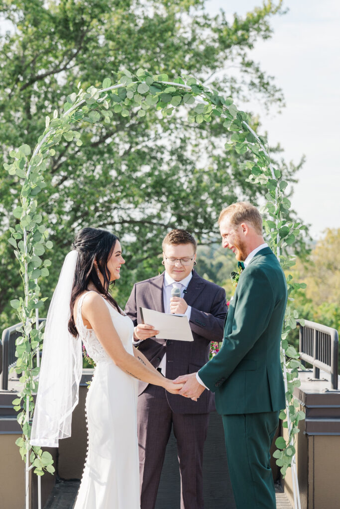 A smiling bride and groom join hands at the altar. 

Central Illinois Wedding Photographer.

Amanda Banik Photography