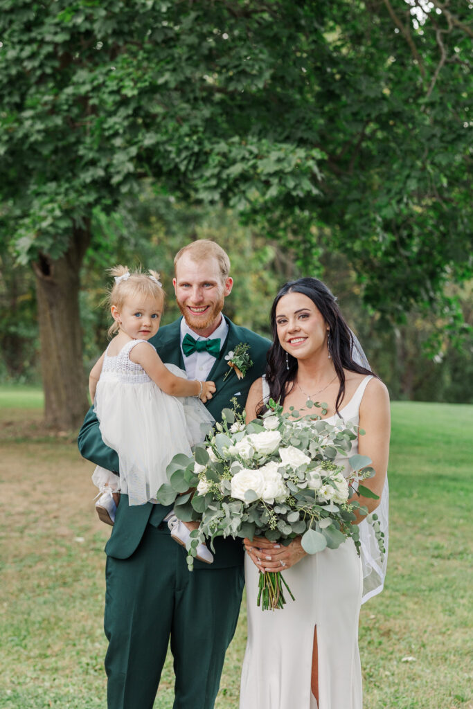 A bride and groom pose with their flower girl. 

Central Illinois Wedding Photographer.

Amanda Banik Photography