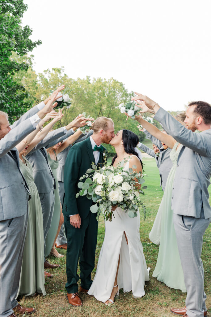 A bride and groom kiss during a bridal party photo on the golf course. 

Central Illinois Wedding Photographer.

Amanda Banik Photography