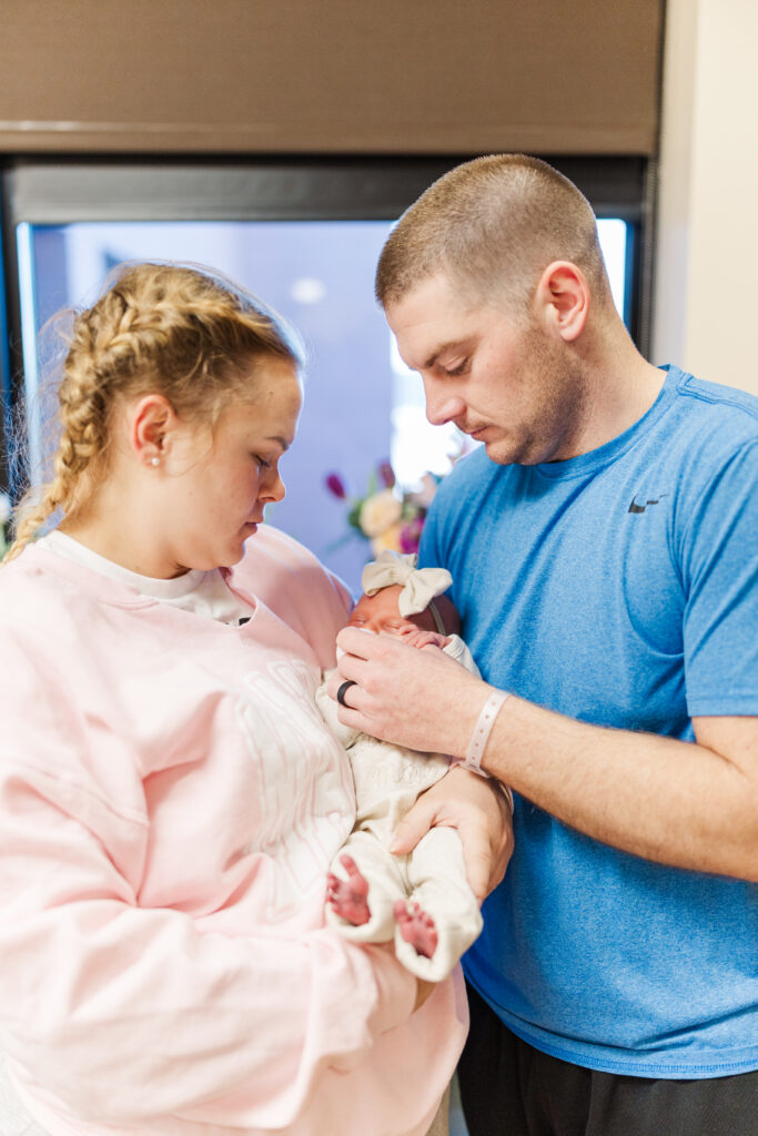 A newborn baby girl cuddles in her parent's arms. 

Champaign Newborn Photographer

Photos by Amanda Banik Photography
