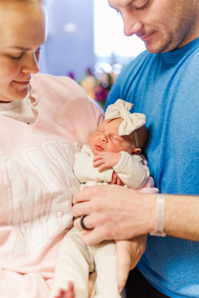 A newborn baby girl cuddles in her parent's arms. 

Champaign Newborn Photographer

Photos by Amanda Banik Photography