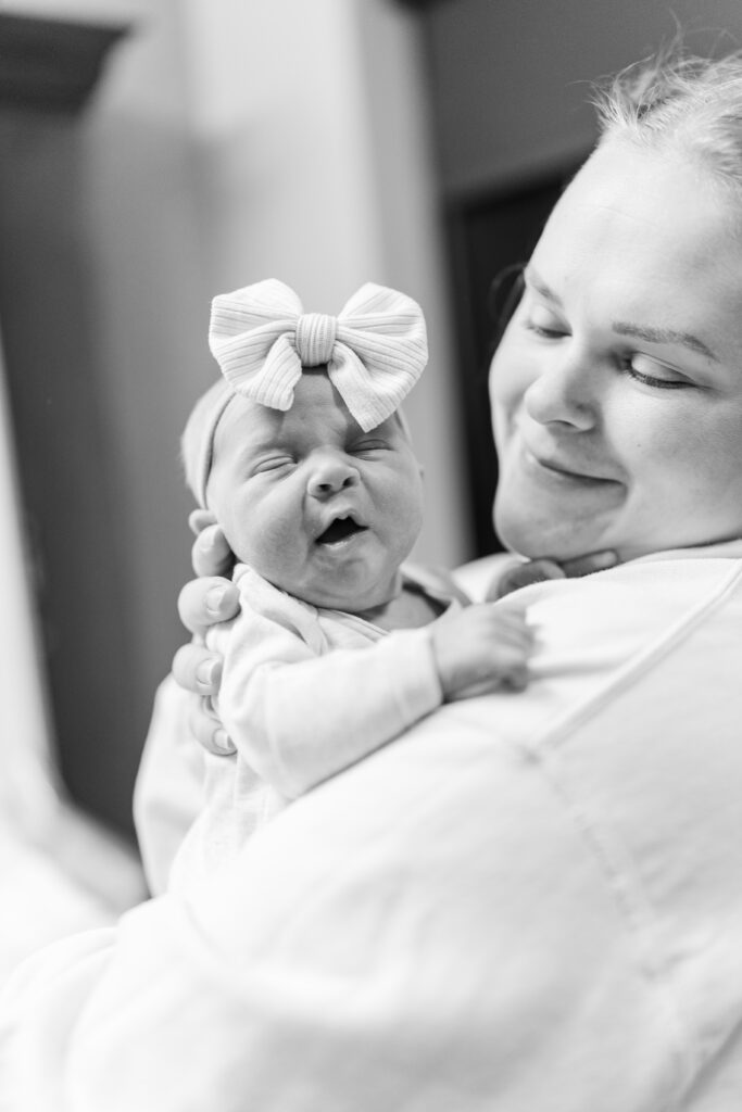 Mom smiling at baby girl during a Fresh 48 Session in Champaign, IL Photos by Amanda Banik Photography