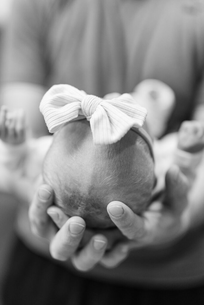 A detail image of a newborn's head in dad's hands during a Fresh 48 Session in Champaign, IL

Photos by Amanda Banik 