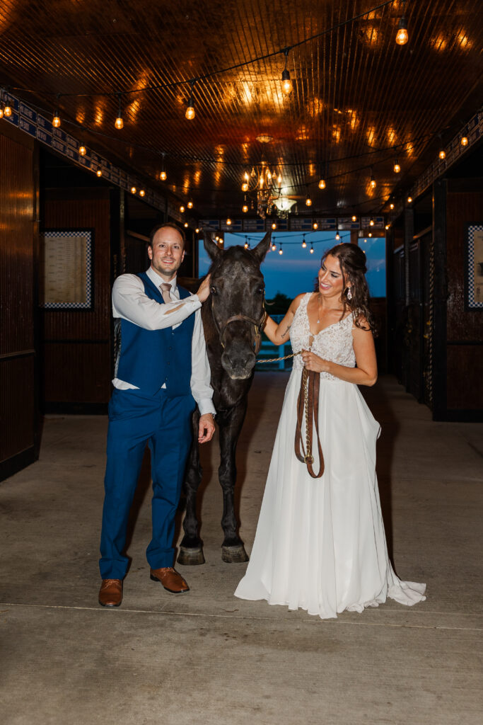 A bride and groom pose for a night time photo with a horse at Northfork Farms. 

Photos by Amanda Banik Photography