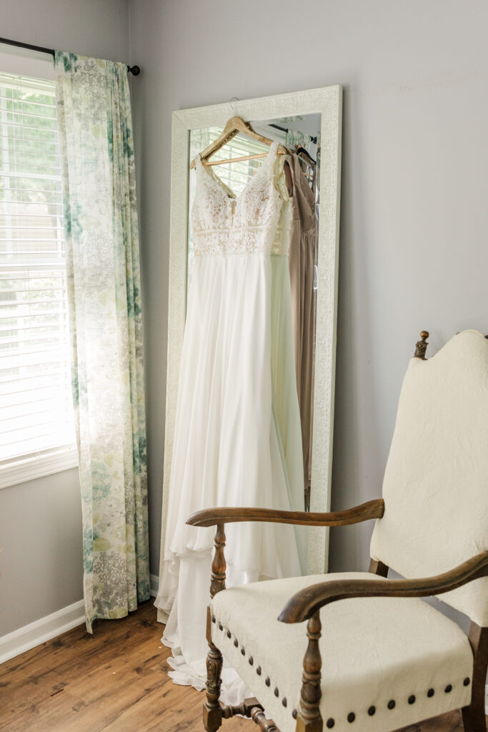 A wedding dress hangs, ready to be worn by a summer bride. 

Northfork Farms, Oswego, IL

Photos by Amanda Banik Photography.