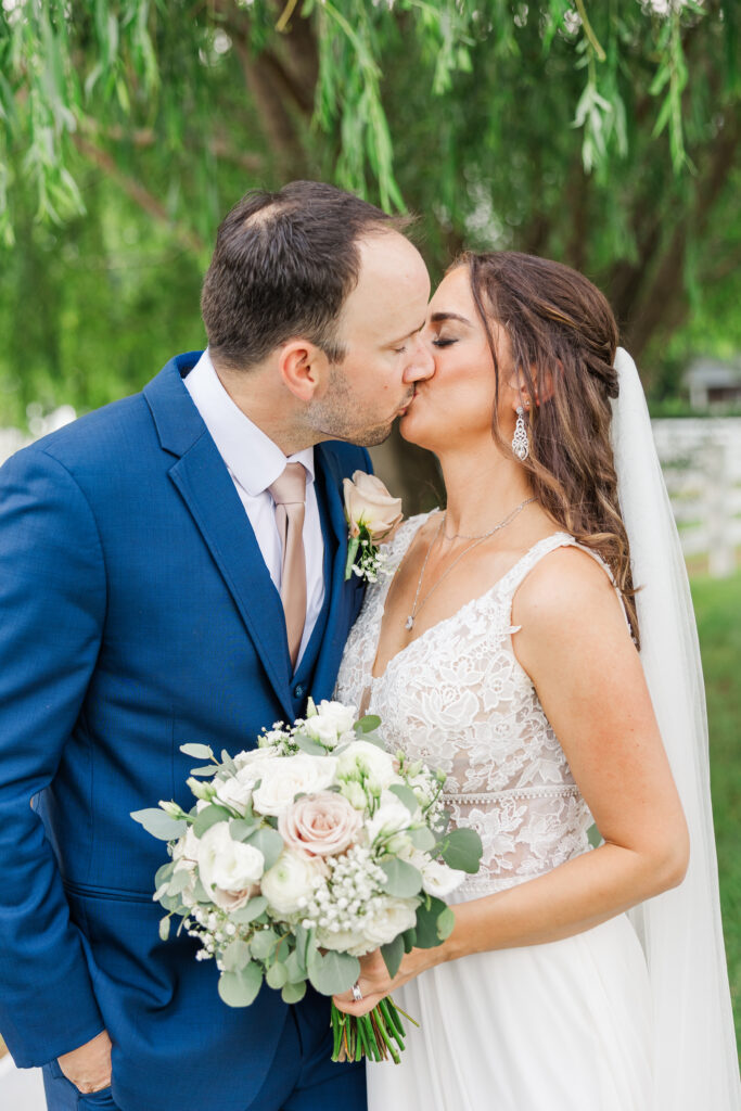 A bride and groom share a kiss during their Central Illinois Summer Wedding. Central Illinois Wedding Photographer. Photos by Amanda Banik Photography