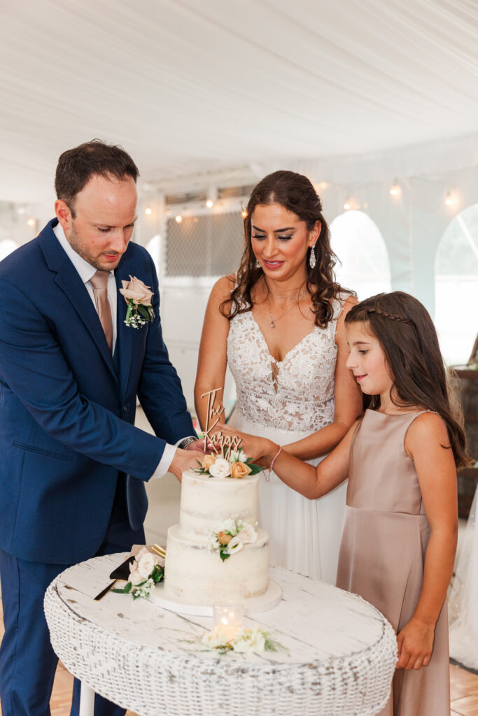 A bride and groom cut their cake with their daughter at Northfork Farms. 

Photos by Amanda Banik Photography