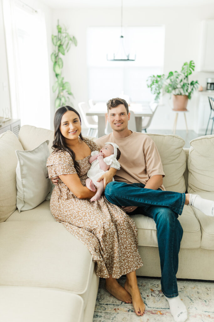 Two new parents sit on the couch while holding their baby.

Central Illinois In-Home Newborn Session.

Photos by Amanda Banik Photography