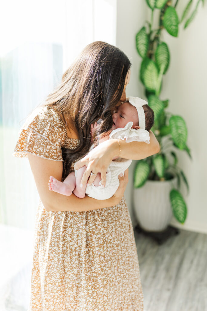 A new mom kisses her newborn baby girl. 

Central Illinois in-home newborn session 

Photos by Amanda Banik Photography