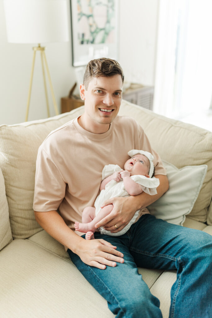 A new dad smiles for a photo with his daughter. 

Central Illinois in-home newborn session 

Photos by Amanda Banik Photography