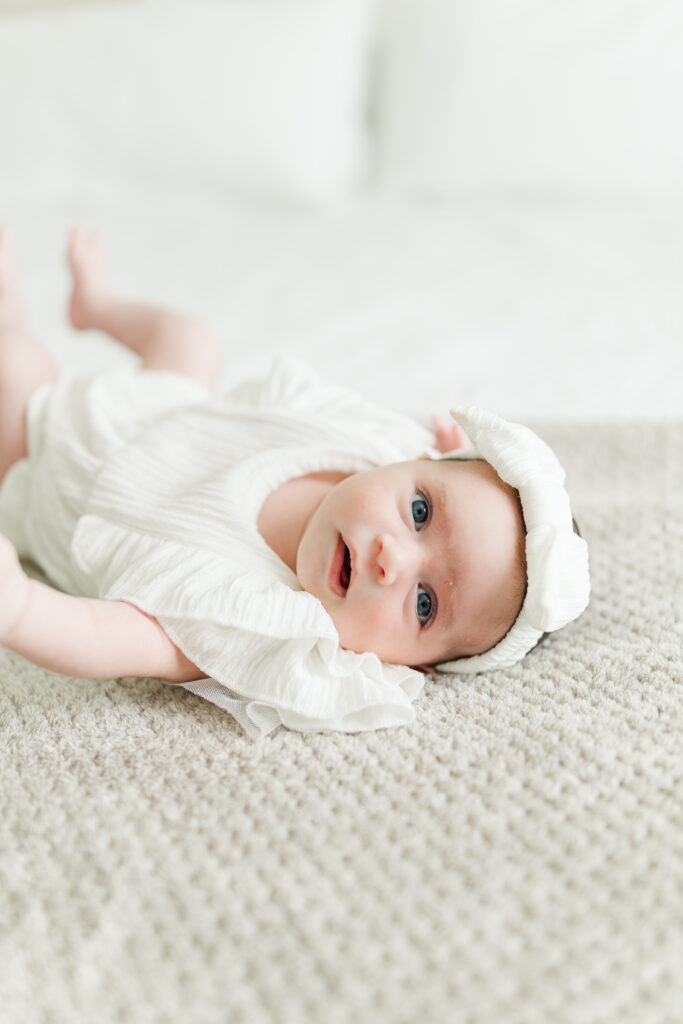 A newborn baby girl lays on the bed during her Central Illinois in-home newborn session 

Photos by Amanda Banik Photography