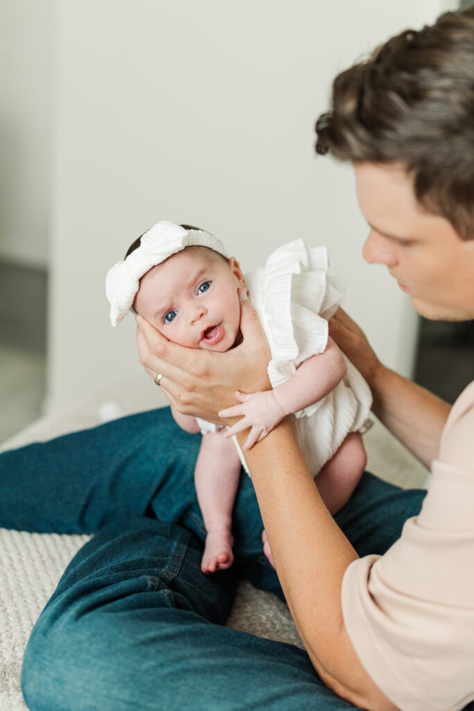 A dad holds his baby up to burp her during their Central Illinois in-home newborn session 

Photos by Amanda Banik Photography